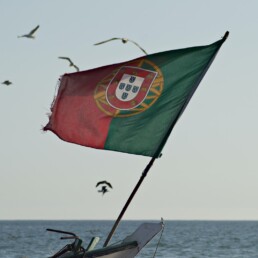 green red and yellow flag on boat during daytime